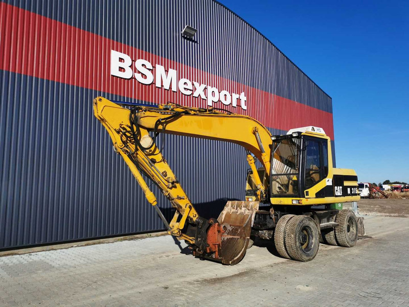 Caterpillar M315 wheel excavator - Bager točkaš: slika 2 Caterpillar M315 wheel excavator - Bager točkaš: slika 2
