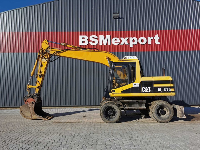 Caterpillar M315 wheel excavator - Bager točkaš: slika 1 Caterpillar M315 wheel excavator - Bager točkaš: slika 1