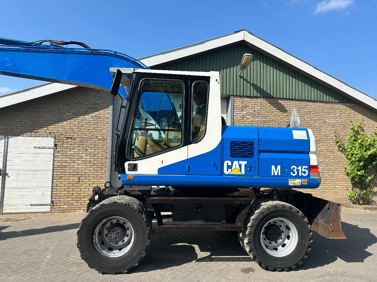 Caterpillar M315 - Bager točkaš: slika 2 Caterpillar M315 - Bager točkaš: slika 2