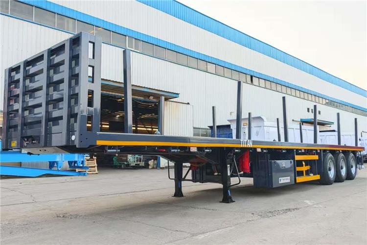 TITAN 3 Axle Flatbed Trailer Truck With Wooden Piles Price In Guma - Poluprikolica za prevoz kontejnera/ Poluprikolica sa promenjivim sandukom: slika 2 TITAN 3 Axle Flatbed Trailer Truck With Wooden Piles Price In Guma - Poluprikolica za prevoz kontejnera/ Poluprikolica sa promenjivim sandukom: slika 2